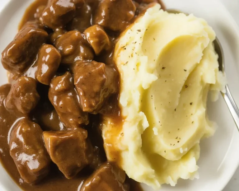 Delicious beef tips with rich brown gravy served over mashed potatoes.